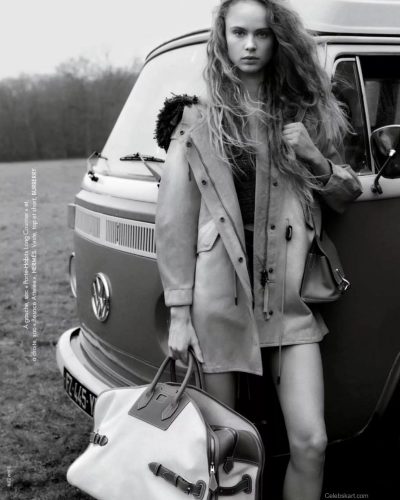 Olivia Vinten in elegant black boots and designer handbag