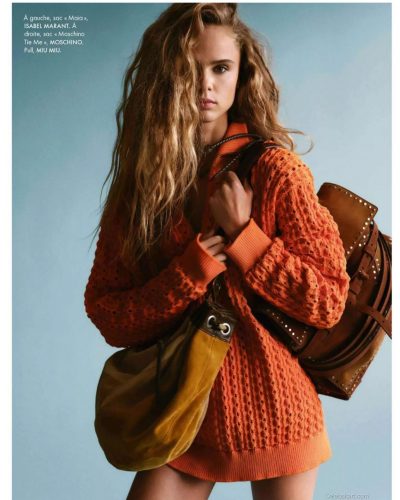 Olivia Vinten in elegant black boots and designer handbag