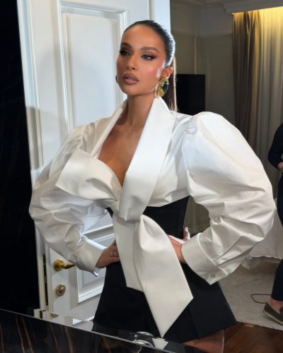 Oriola Marashi in bold white blouse and contrasting black shorts