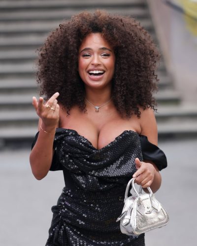 Paola Locatelli styled in a black sequined gown with elegant ruffles.