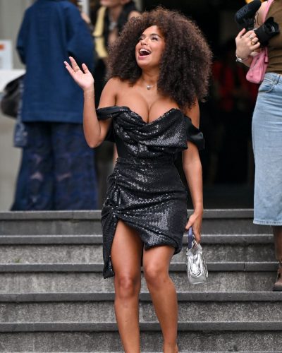 Paola Locatelli styled in a black sequined gown with dramatic sleeves.