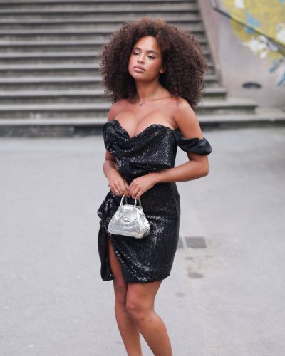 Paola Locatelli wearing a black sequined gown with playful ruffled design.