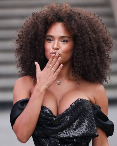 Paola Locatelli in black sequined dress with ruffles and billowing sleeves.