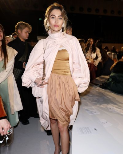Paris Jackson styled in pink coat and classic beige dress