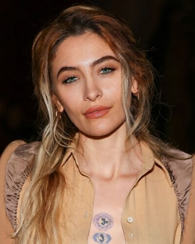 Paris Jackson stylish handbag complementing tan fitted dress