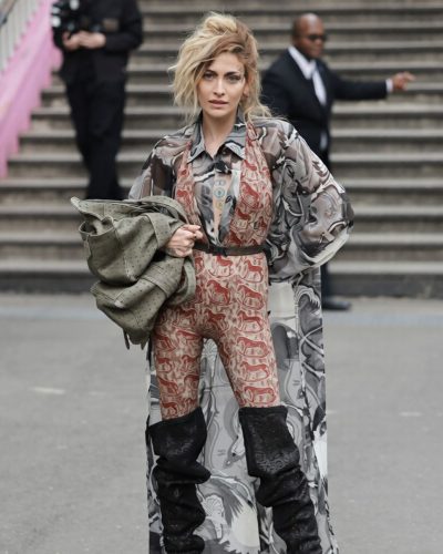 Paris Jackson chic knee-high boots complementing bold fashion choice
