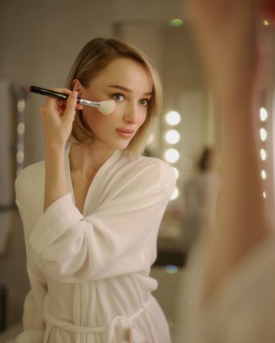 Phoebe Dynevor airy white tunic and fitted black pants