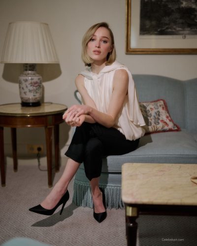 Phoebe Dynevor soft, flowing white top and black trousers