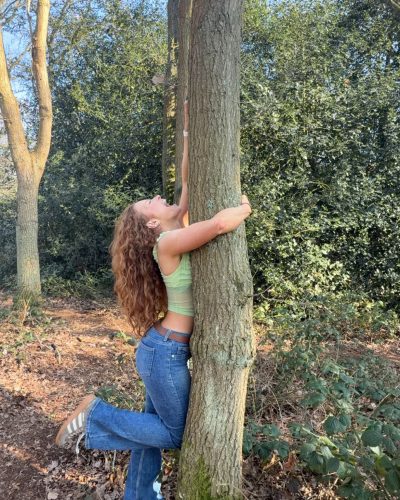 Phoebe Ginger in vibrant green top paired with high-waisted jeans