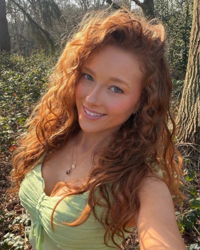 Phoebe Ginger wearing a fitted green top with textured detailing