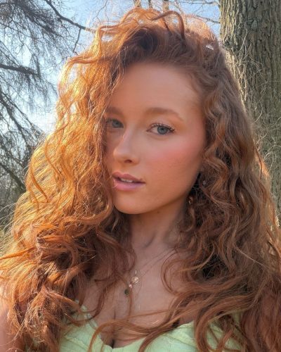 Phoebe Ginger in casual denim jeans and vibrant green top