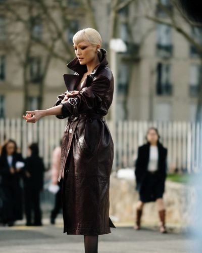 Pom Klementieff in burgundy leather coat with oversized collar