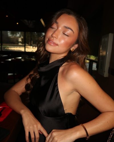 Presley Elise styled in a minimalist black dress with bracelet.