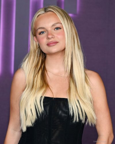 Pressley Hoshbach flowing black dress paired with stylish silver heels