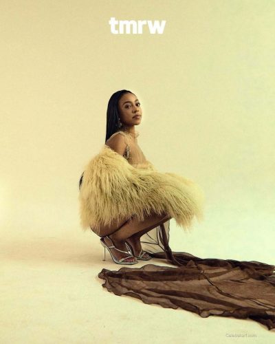 Priah Ferguson in fluffy outerwear paired with flowing skirt.