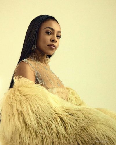 Priah Ferguson in delicate lace top and soft pastel skirt.