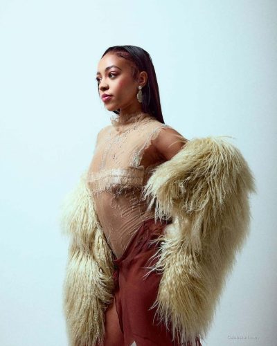 Priah Ferguson in lace top paired with soft pastel flowing skirt.