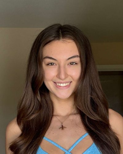 Rachel Pizzolato vibrant green and yellow bikini by the ocean