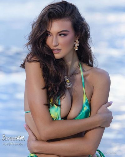 Rachel Pizzolato accessorized with oversized earrings and vibrant swimwear