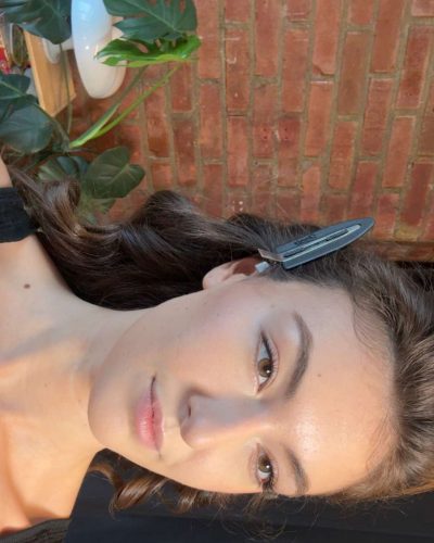 Rachel Pizzolato black tank top in creative brick wall setting