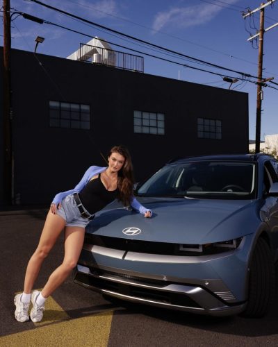 Rachel Pizzolato red dress reflecting warm lighting