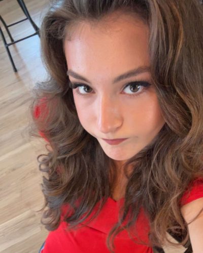 Rachel Pizzolato red dress accentuated with a stylish belt