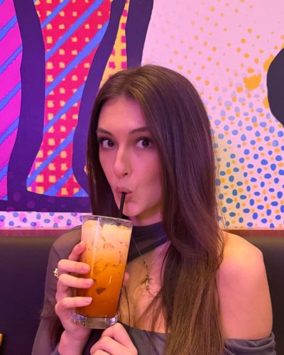 Rachel Pizzolato gray dress with long sheer sleeves and knee-high boots