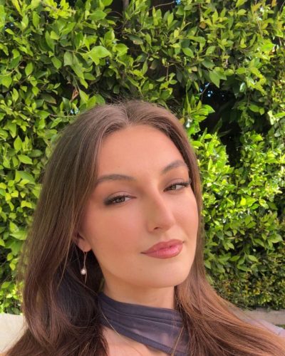 Rachel Pizzolato black knee-high boots and gray long sleeve dress