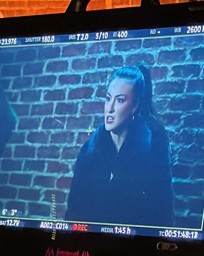 Rachel Pizzolato in a simple black swimsuit with a cheerful expression.