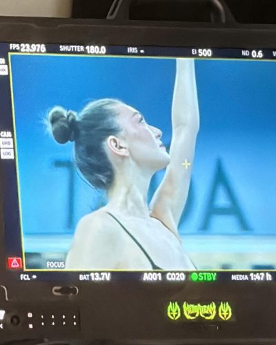 Rachel Pizzolato wearing a chic black swimsuit by the pool.
