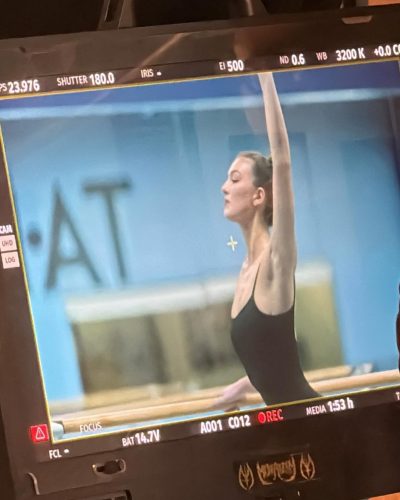 Rachel Pizzolato in a black swimsuit with delicate necklace.