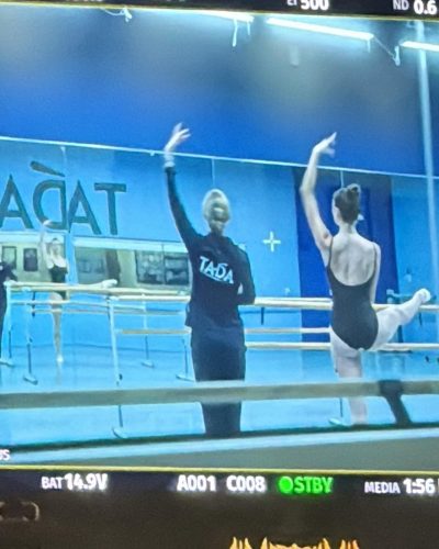 Rachel Pizzolato wearing a black swimsuit in a serene environment.