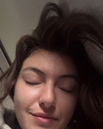 Rachel Pizzolato gray dress with sheer sleeves and black footwear