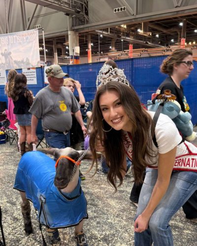 Rachel Pizzolato stylish gray mini dress and edgy black knee-high boots