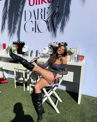 Rachel Pizzolato trendy gray mini dress with bold red accent pillow