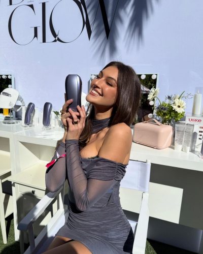 Rachel Pizzolato gray dress and black boots against lush greenery backdrop