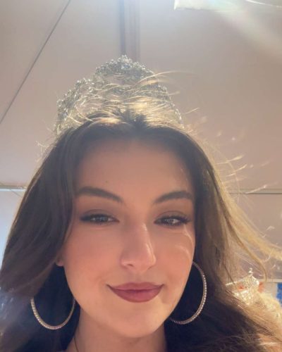 Rachel Pizzolato vibrant red pillow with gray mini dress and black boots