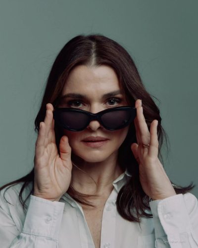 Rachel Weisz in chic white shirt tucked into high-waisted denim.