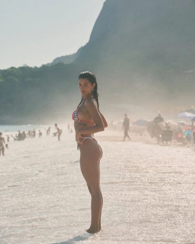 Ray Bitancourt in chic bikini with intricate designs and vibrant colors.