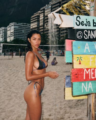 Ray Bitancourt wearing colorful triangle bikini with playful patterns.