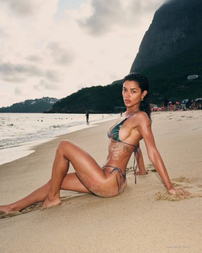 Ray Bitancourt in playful bikini with refreshing color palette by the ocean.