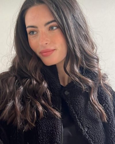 Renee Murden in vibrant yellow swimsuit with flowing hair.