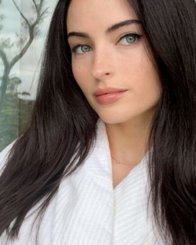 Renee Murden in yellow bikini gazing over her shoulder.