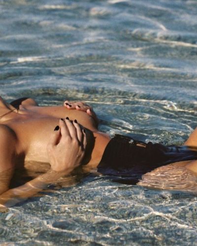 Renee Murden in black high-waisted bikini under golden hour light