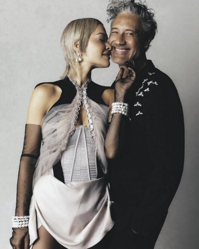 Rita Ora in flowing pink dress with pearl jewelry