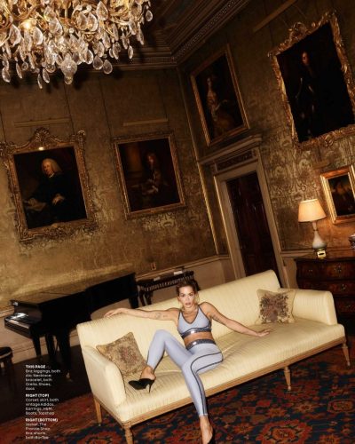 Rita Ora in sleek black swimsuit featuring modern striped accents