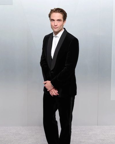 Robert Pattinson with polished black dress shoes and black tuxedo