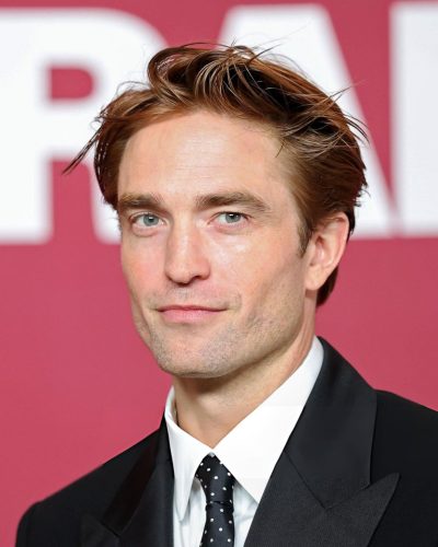 Robert Pattinson in sleek black suit with sharp lapels