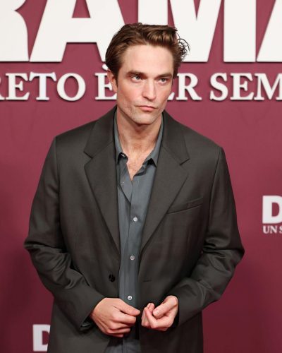 Robert Pattinson dressed in a contemporary dark suit and blue shirt.