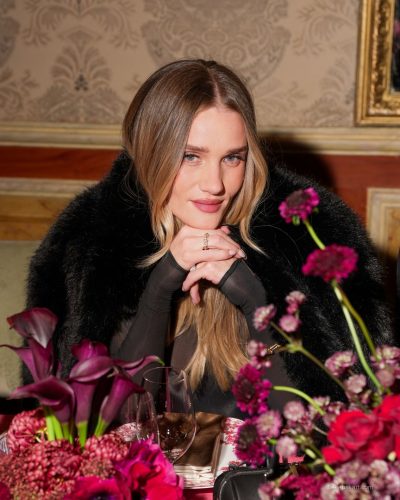 Rosie Huntington-Whiteley chic black fur coat over fitted black dress.